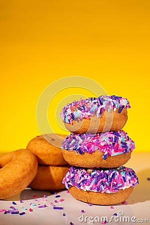 A stack of pink sprinkle donuts Stock Photo