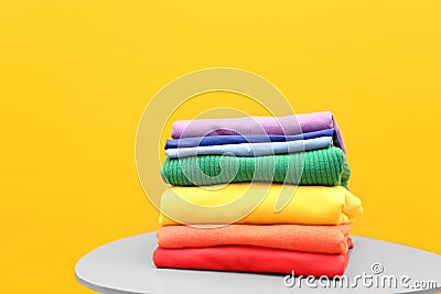 Stack of rainbow clothes on table Stock Photo