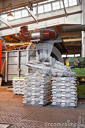 Stack of raw aluminum ingots in factory Stock Photo