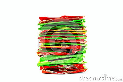 Stack of Red, Yellow and Green Foil Plastic Snack Packaging. Unhealthy Food, Recycling Concept Stock Photo