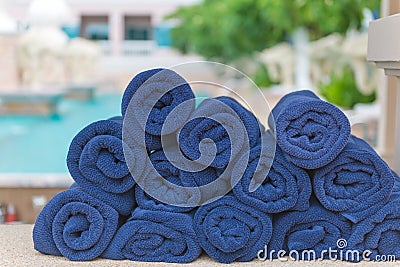 Stack roll of bath blue towels on table at swimming pool Stock Photo