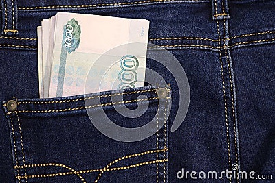 A stack of Russian thousand-ruble bills in a pocket of blue jeans. Money in your pocket, cash. Travel concept Stock Photo