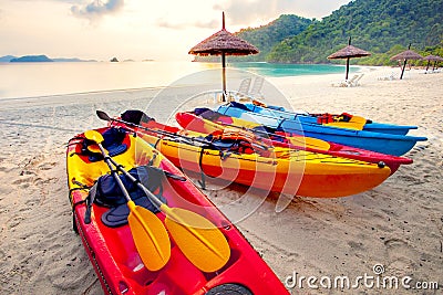 Stack of sea kayak on beautiful sand beach against morning usn rising Stock Photo