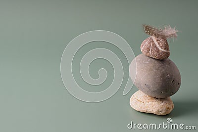 A stack of sea stones on a pastel background. Balance concept, copy space. Spiritual relaxation, zen. Pyramid of pebbles, harmony Stock Photo