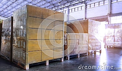 Stack of shipments boxes on wooden pallets. Interior of warehouse storage Stock Photo