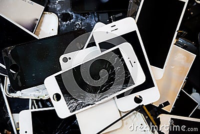 Stack of smart phones with cracked and damaged LCD screen Stock Photo