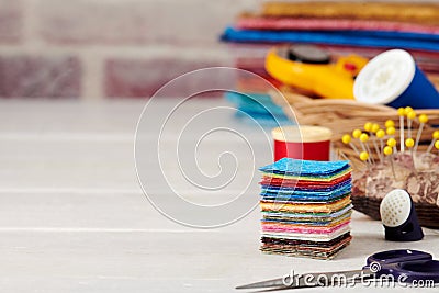 Stack of square pieces of colorful fabrics, accessories for quilting Stock Photo