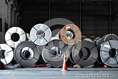 Stack of steel coil in storage warehouse. Steel coils handling equipment. Steel warehouse and logistics operations. Stock Photo