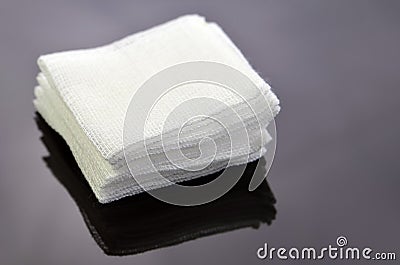 Stack of sterile gauze pad on dark background. Stock Photo