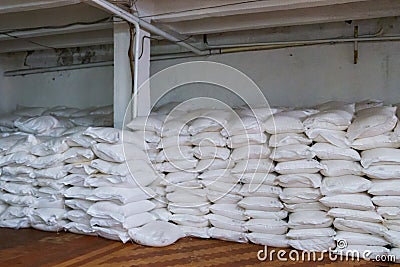 Stack of sugar or flour bags in warehouse Stock Photo