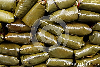 Stack of Suman sa Lihiya or steamed glutenous rice wrapped in banana leaves Stock Photo