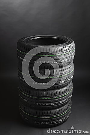 Stack of summer tires, gray background Stock Photo