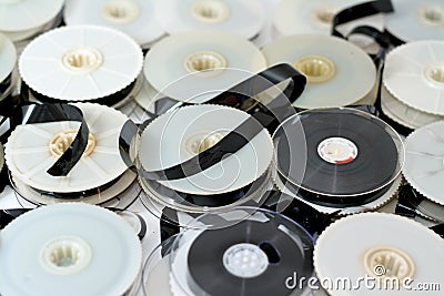 Stack of supply and take up reels with ribbon of VHS video cassette tapes used on old video players and recorders, retro style Stock Photo