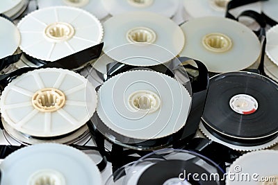 Stack of supply and take up reels with ribbon of VHS video cassette tapes used on old video players and recorders, retro style Stock Photo