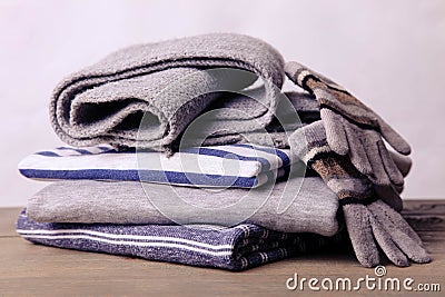 A stack of sweatshirts, a scarf and gloves Stock Photo