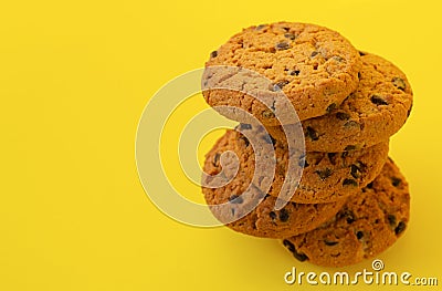 Stack of tasty chocolate chip cookies on yelllow background Stock Photo