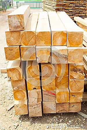 Stack of teak wood square in lumber yard. pile Wooden Stock Photo