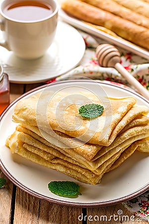 Stack of thin pancakes crepes bliny served with honey Stock Photo