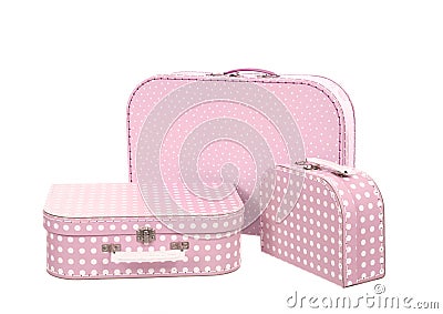 Stack of three suitcases, pink with white dots Stock Photo