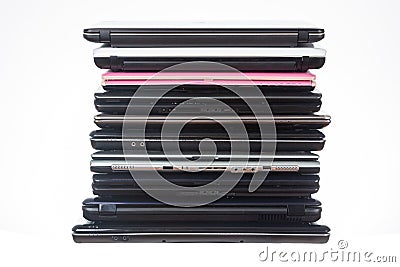 Stack of used laptops in different colors and models. T Stock Photo