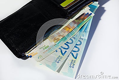 Stack of various of israeli shekel money bills in open black lea Stock Photo