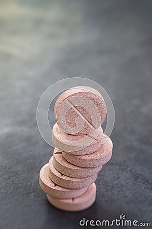 Stack of vitamin mineral supplement effervescent tablets on slate background Stock Photo