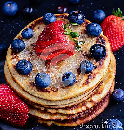 Stack of wholemeal pancakes with fresh fruits Stock Photo