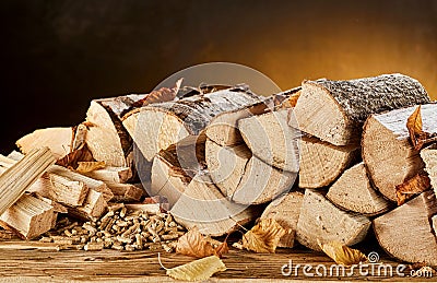 Stack of wood logs sitting on top of table Stock Photo