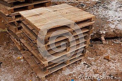 Stack wooden palle at a construction site. Pallets for transportation of goods Stock Photo