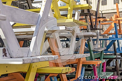 An abstract stack of multi coloured wooden tables Stock Photo