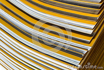 Stack of yellow monthly magazine Stock Photo