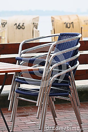 Stacked chairs on the beach Stock Photo