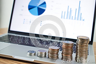 Stacked coins placed on the laptop as a background. Business finance concept Stock Photo