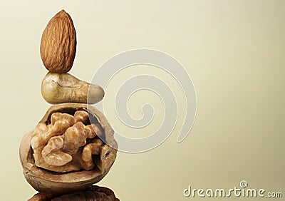 Stacked different nuts on beige gradient background, space for text Stock Photo