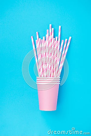 Stacked Drinking Paper Cups with Striped Straws on Mint Blue Background. Flat Lay Composition. Birthday Party Celebration Kids Fun Stock Photo