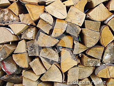 Stack of firewood, wood logs texture background.Pile of chopped fire wood prepared for winter Stock Photo