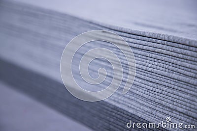 Stacked folded Gray fabric Surface Texture Background. Selective Focus Stock Photo