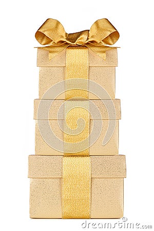Stacked gold gift boxes wrapped with shiny golden ribbon and bow isolated on white Stock Photo