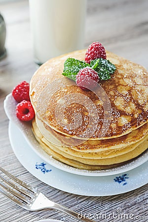 Stacked pancakes raspberries mint sugar milk Stock Photo