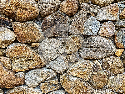Stacked stone wall with crumbling mortar Stock Photo