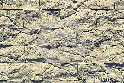 Stacked stone wall, natural stone cladding. Stone wall for background. Wall background of volcanic andesite basalt stone texture. Stock Photo