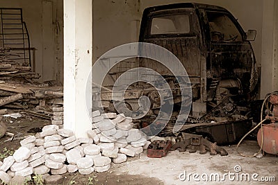 Stacked stones near a pillar with a broken down pick up vehicle on the back with vintage looks Stock Photo