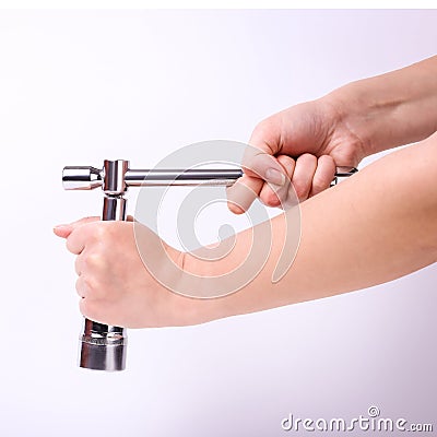 Stacked wrench in the hand of a girl. Symbol of hard work, feminism and labor day. Isolate on white background Stock Photo