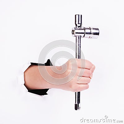 Stacked wrench in the hand of a girl. Symbol of hard work, feminism and labor day. Isolate on white background Stock Photo