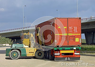 Stacker lifting a container Stock Photo