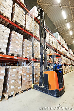 Stacker in modern big warehouse Stock Photo