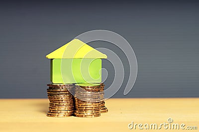 A stacking gold coins and home. Housing Loan Stock Photo