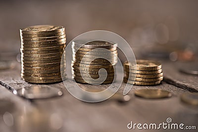 Stacks of coins on wooden tabletop Stock Photo