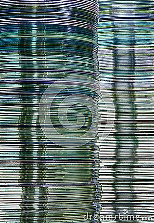 Data storage abstract background showing layered stacks of translucent metallic DVD and CD computer storage disks Stock Photo