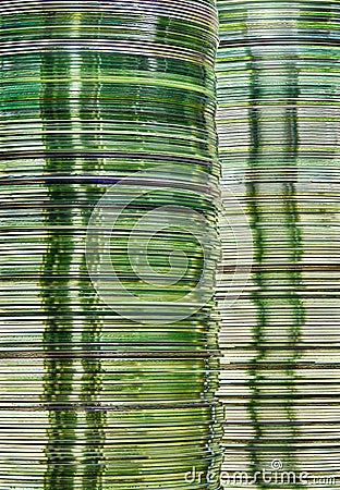 Data storage image with layered stacks of translucent green gold DVD and CD computer storage disks Stock Photo